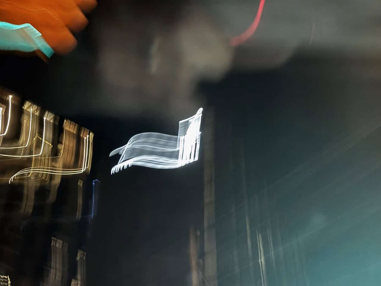 Abstract night scene in Nashville with blurred lights, showcasing streaks of white and yellow against a dark background, capturing the city's vibrant motion.