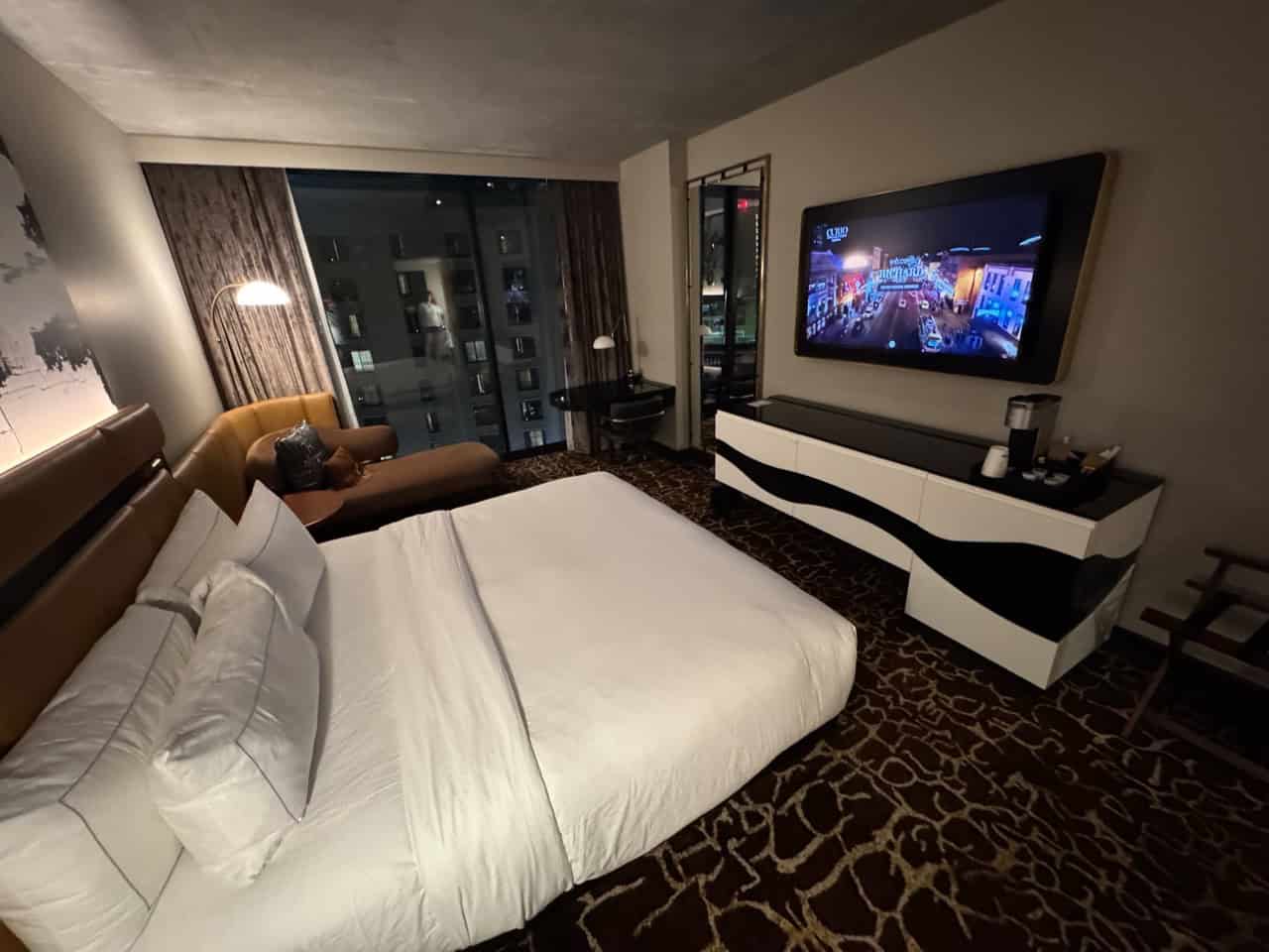 Experience the charm of Nashville in this hotel room featuring a king-size bed, a cozy chaise lounge, and a large flat-screen TV. Revel in the stunning city view that perfectly captures the vibrant essence of Music City.
