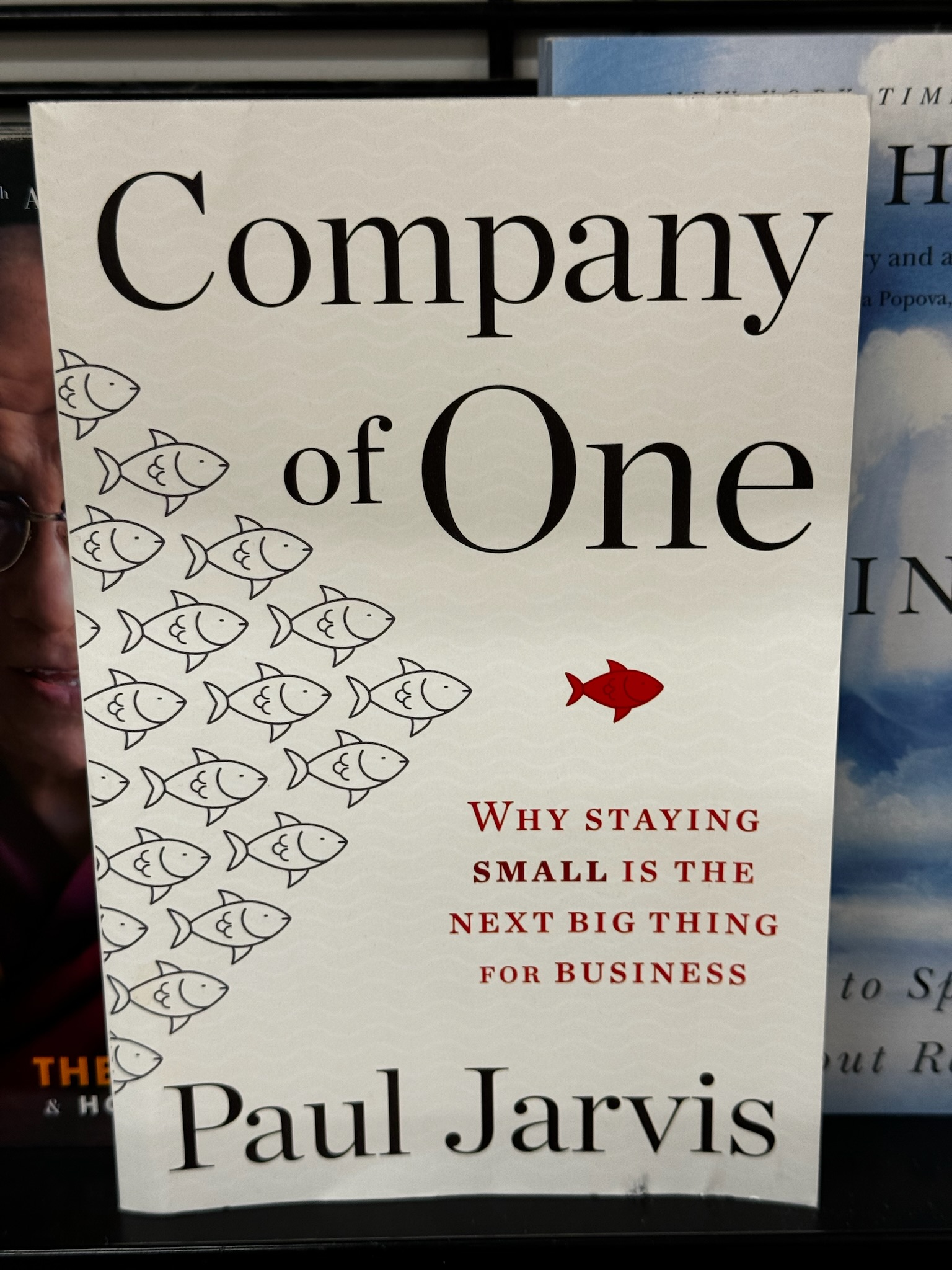 The cover of the book "Company of One" by Paul Jarvis, featuring small fish swimming left and one red fish swimming right, with the subtitle "Why staying small is the next big thing for business.